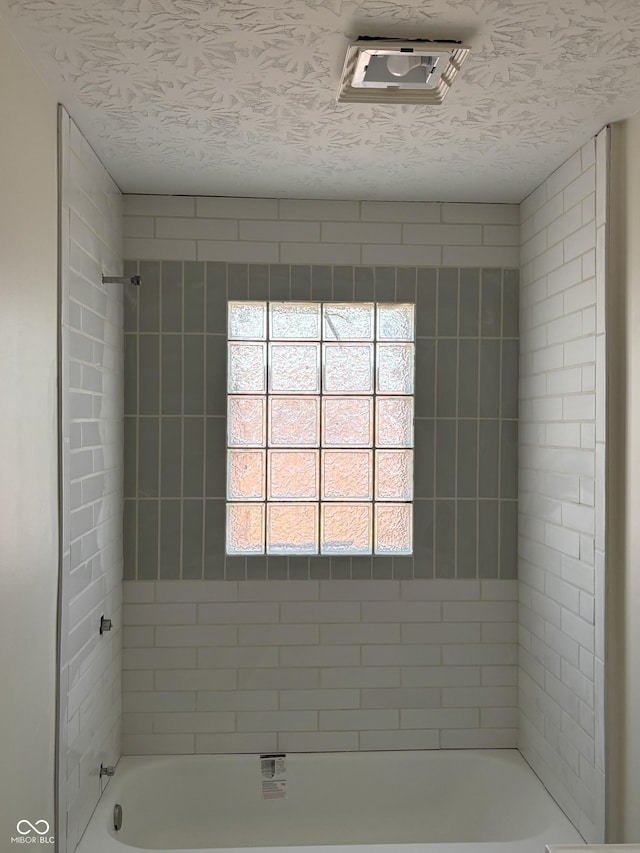 full bathroom featuring visible vents, a textured ceiling, and shower / washtub combination
