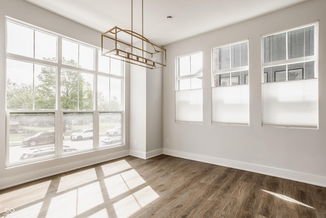 401 Jersey St, Westfield, IN 46074 - unfurnished dining area with baseboards, wood finished floors, and a chandelier