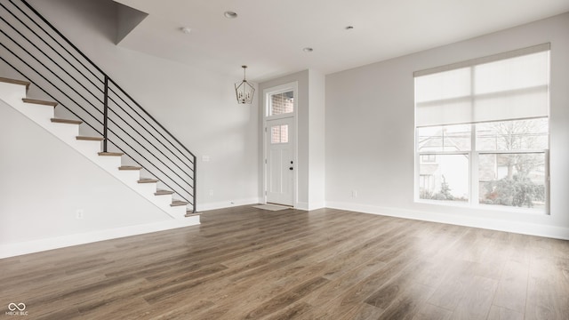 401 Jersey St, Westfield, IN 46074 - foyer featuring baseboards, stairs, an inviting chandelier, and wood finished floors