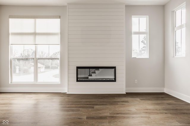 401 Jersey St, Westfield, IN 46074 - unfurnished living room featuring wood finished floors, a wealth of natural light, and a large fireplace