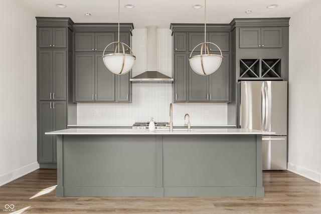 401 Jersey St, Westfield, IN 46074 - kitchen featuring baseboards, freestanding refrigerator, a kitchen island with sink, and wall chimney range hood