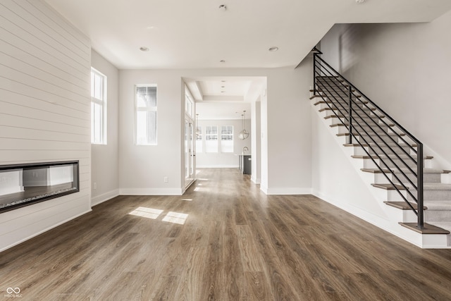 401 Jersey St, Westfield, IN 46074 - unfurnished living room featuring baseboards, stairs, a fireplace, and wood finished floors