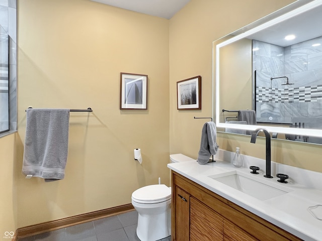 1026 Jackson St, Columbus, IN 47201 - bathroom featuring tiled shower, toilet, tile patterned flooring, vanity, and baseboards