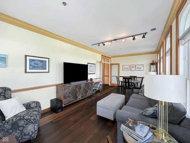 1026 Jackson St, Columbus, IN 47201 - living area featuring rail lighting, ornamental molding, hardwood / wood-style flooring, and baseboards