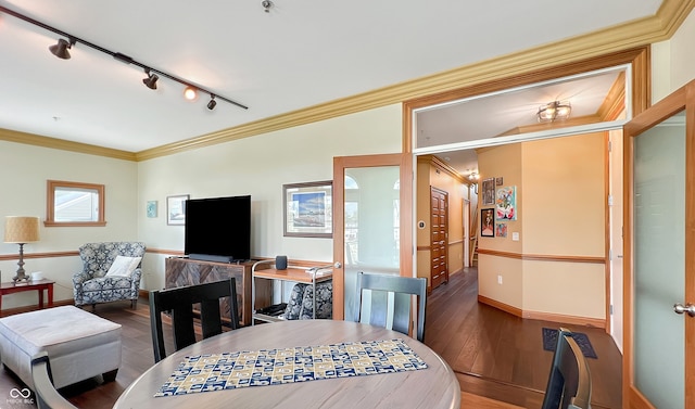 1026 Jackson St, Columbus, IN 47201 - dining space with rail lighting, wood finished floors, ornamental molding, and baseboards