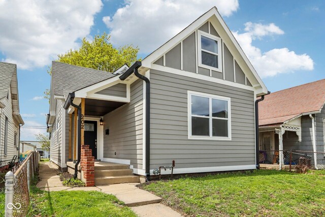 202 Mckim Ave, Indianapolis, IN 46201 - bungalow with board and batten siding, fence, and a front yard