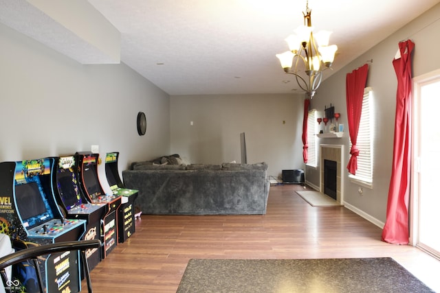 1831 Brook Crossing Way, Indianapolis, IN 46229 - living area featuring a tiled fireplace, wood finished floors, and a notable chandelier