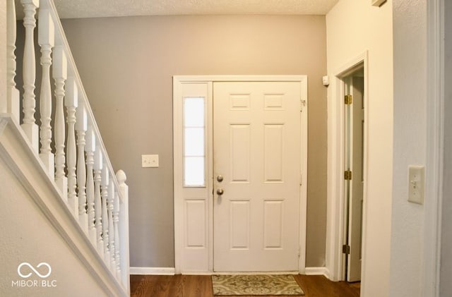 1831 Brook Crossing Way, Indianapolis, IN 46229 - entryway with baseboards, dark wood-style floors, and stairway
