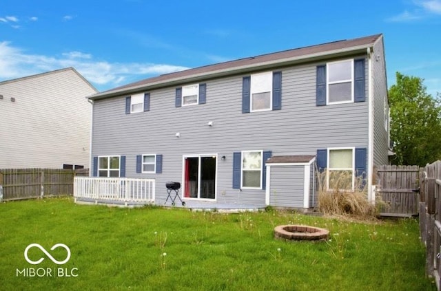 1831 Brook Crossing Way, Indianapolis, IN 46229 - back of house featuring a fenced backyard, a yard, and a fire pit