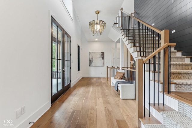 11064 Hamilton Run, Zionsville, IN 46077 - foyer with a chandelier, stairway, hardwood / wood-style floors, baseboards, and french doors