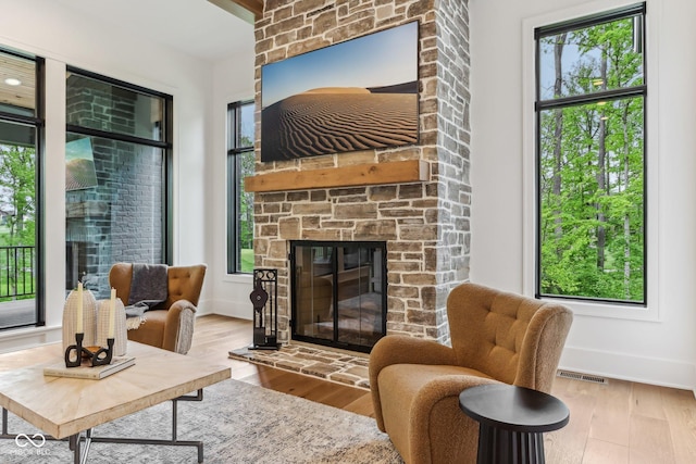 11064 Hamilton Run, Zionsville, IN 46077 - living area featuring a fireplace, wood finished floors, and baseboards