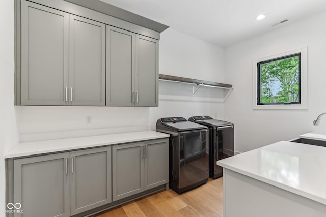11064 Hamilton Run, Zionsville, IN 46077 - laundry room featuring cabinet space, washing machine and clothes dryer, light wood-type flooring, and recessed lighting