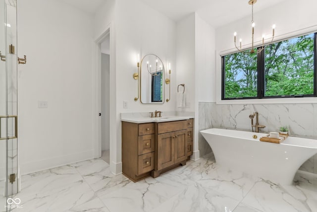 11064 Hamilton Run, Zionsville, IN 46077 - bathroom with a chandelier, marble finish floors, a soaking tub, vanity, and baseboards