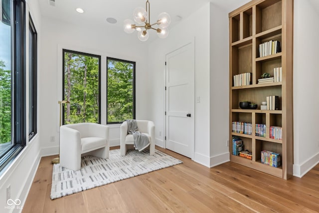 11064 Hamilton Run, Zionsville, IN 46077 - sitting room with wood-type flooring, a chandelier, and baseboards