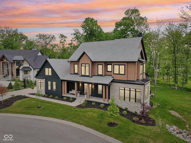 11064 Hamilton Run, Zionsville, IN 46077 - view of front facade featuring covered porch, stone siding, roof with shingles, a standing seam roof, and a chimney