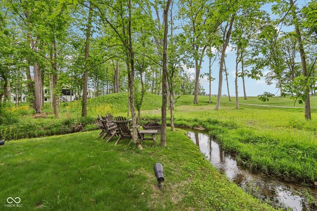 11064 Hamilton Run, Zionsville, IN 46077 - view of green lawn featuring an outdoor fire pit