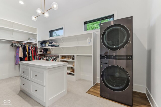 11064 Hamilton Run, Zionsville, IN 46077 - laundry room featuring stacked washer / drying machine and a chandelier