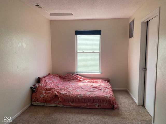 2350 Harvest Moon Dr, Greenwood, IN 46143 - carpeted bedroom featuring baseboards, a textured ceiling, and visible vents