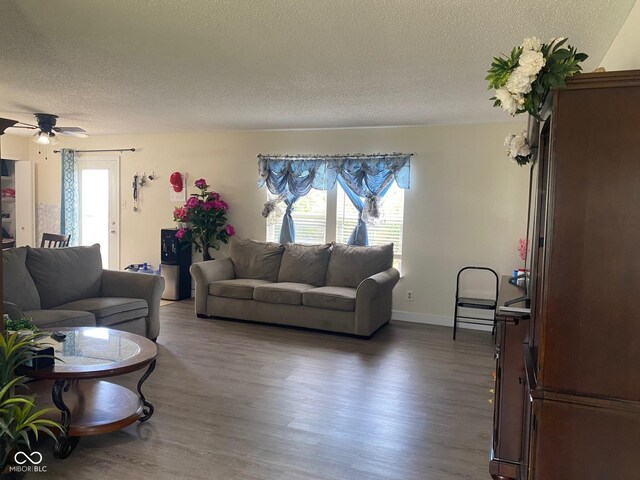 2350 Harvest Moon Dr, Greenwood, IN 46143 - living room featuring baseboards, ceiling fan, a textured ceiling, and wood finished floors