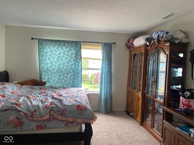 2350 Harvest Moon Dr, Greenwood, IN 46143 - bedroom featuring visible vents, a textured ceiling, and light colored carpet