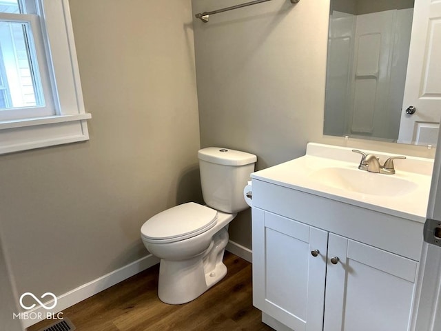 full bathroom with baseboards, vanity, toilet, and wood finished floors