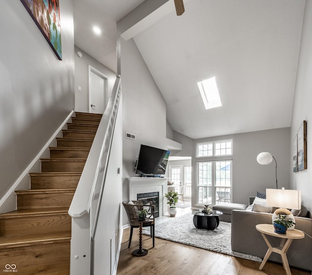 2823 Somerset Bay, Indianapolis, IN 46240 - living area with high vaulted ceiling, stairway, a tile fireplace, and wood finished floors