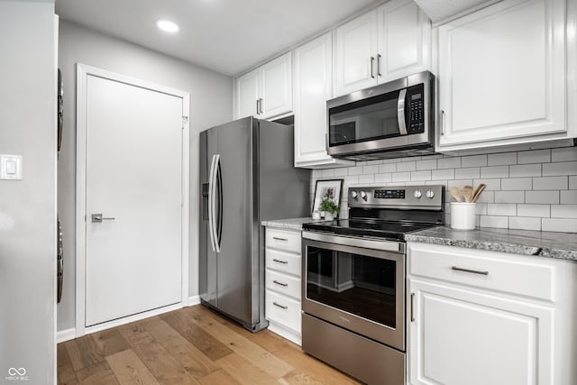 2823 Somerset Bay, Indianapolis, IN 46240 - kitchen featuring appliances with stainless steel finishes, backsplash, white cabinetry, light wood-style flooring, and recessed lighting