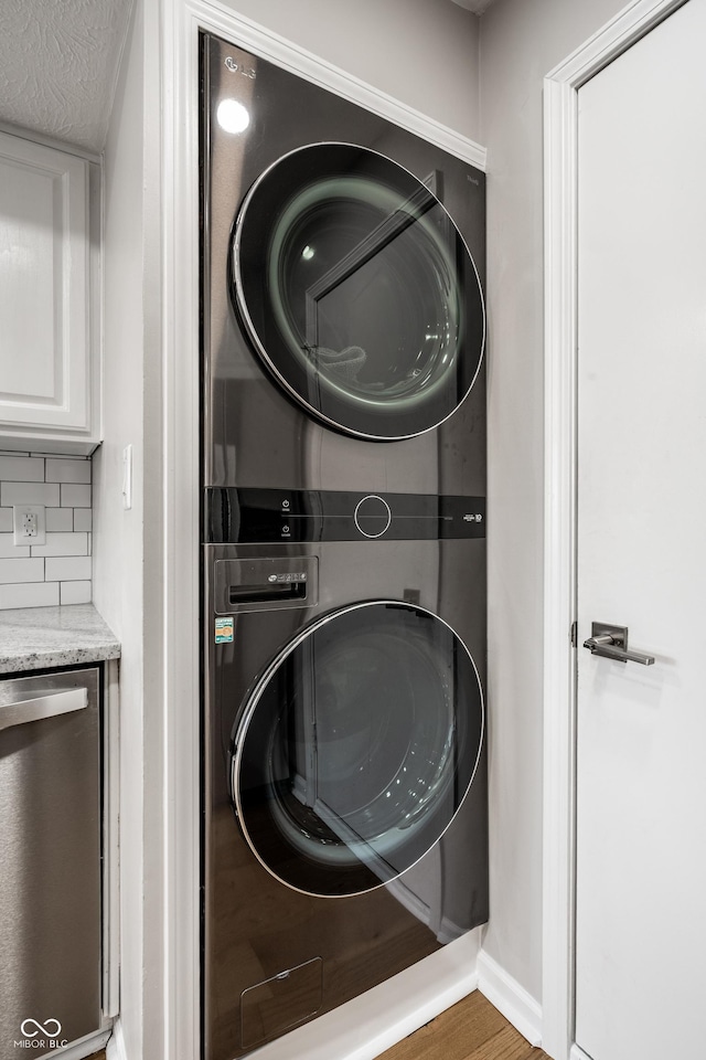 2823 Somerset Bay, Indianapolis, IN 46240 - laundry room with stacked washer and clothes dryer and wood finished floors