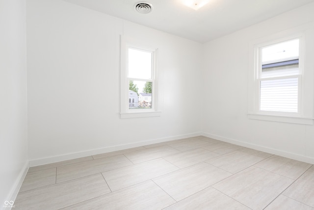 empty room with visible vents and baseboards