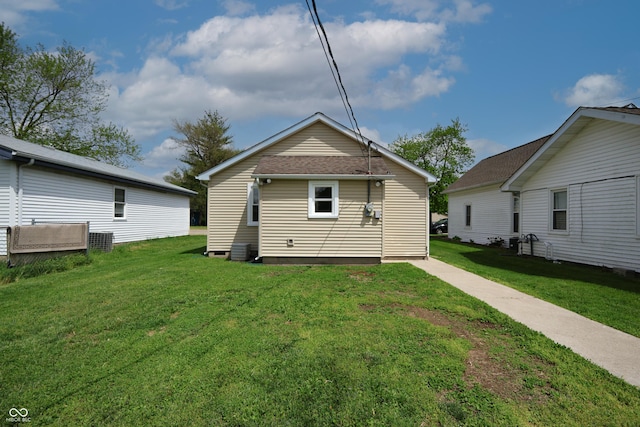 rear view of house featuring a yard