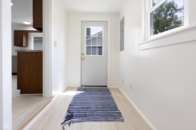 doorway with light wood-style floors and electric panel