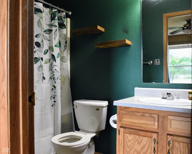 full bath featuring toilet, a textured wall, and vanity
