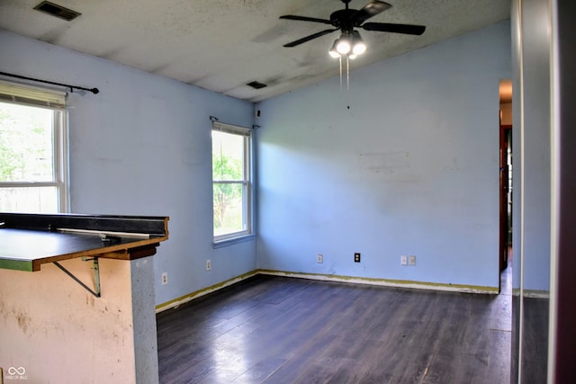 unfurnished room featuring ceiling fan, visible vents, wood finished floors, and vaulted ceiling