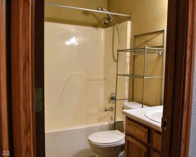 full bathroom with vanity, a textured wall, toilet, and bathing tub / shower combination