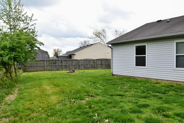 view of yard featuring a fire pit and a fenced backyard