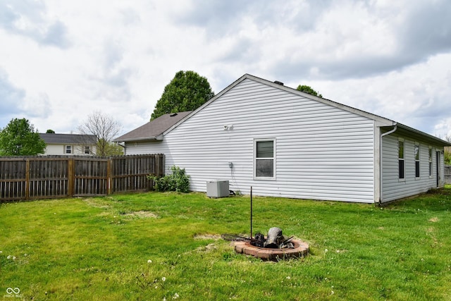 view of home's exterior featuring a yard, fence, and cooling unit