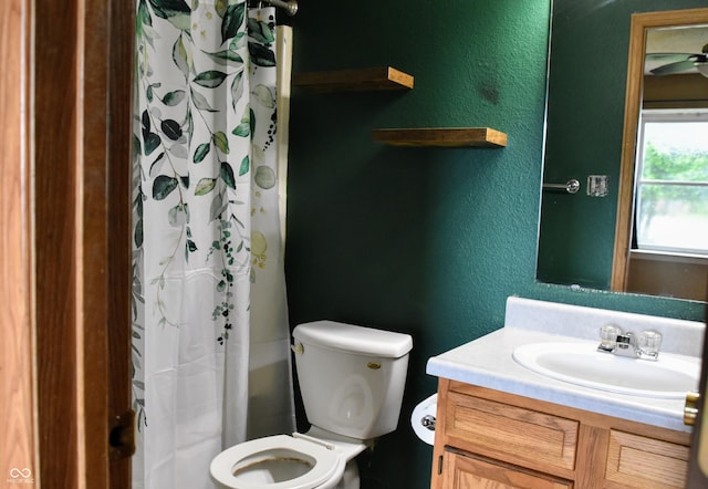 full bathroom with vanity, a textured wall, and toilet