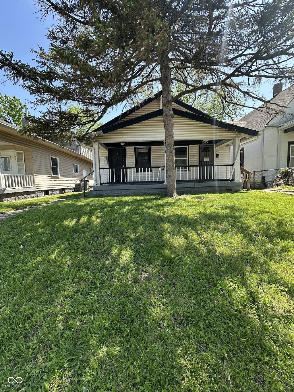 1513 N Kealing Ave, Indianapolis, IN 46201 - back of house with a yard and a porch