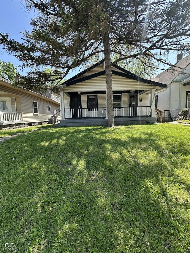 1513 N Kealing Ave, Indianapolis, IN 46201 - back of house with a yard and a porch