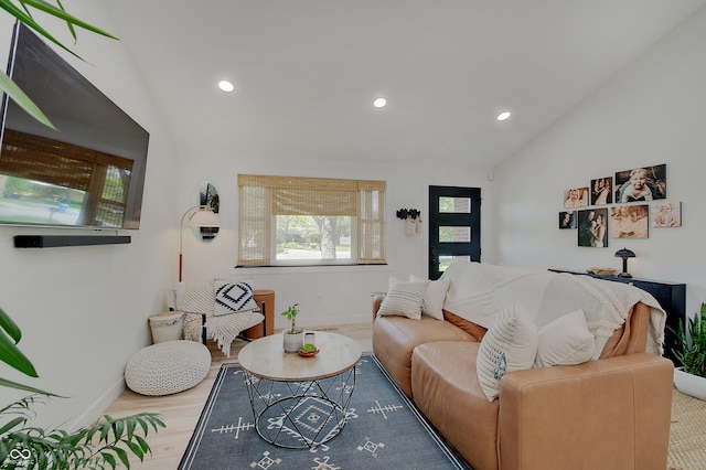 living area with baseboards, recessed lighting, lofted ceiling, and wood finished floors