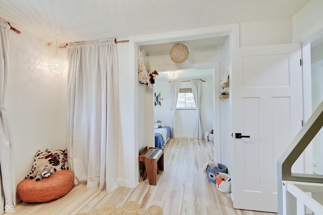 hall featuring wood finished floors and baseboards