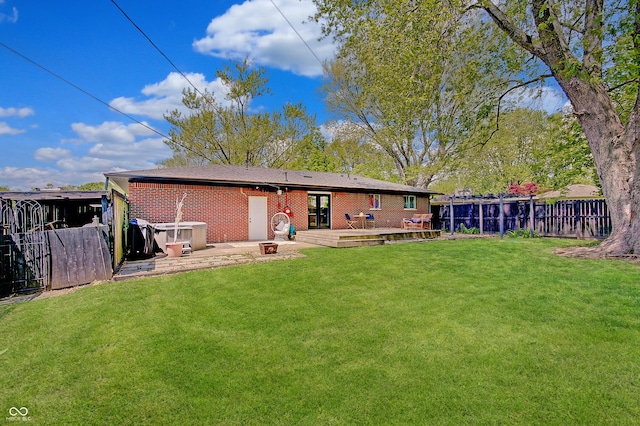 back of property with a deck and brick siding