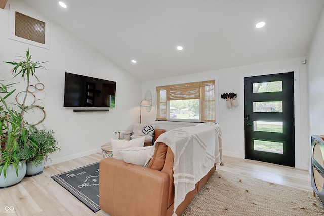 living room with lofted ceiling, wood finished floors, recessed lighting, and baseboards