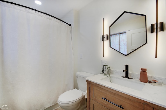 bathroom with toilet and vanity
