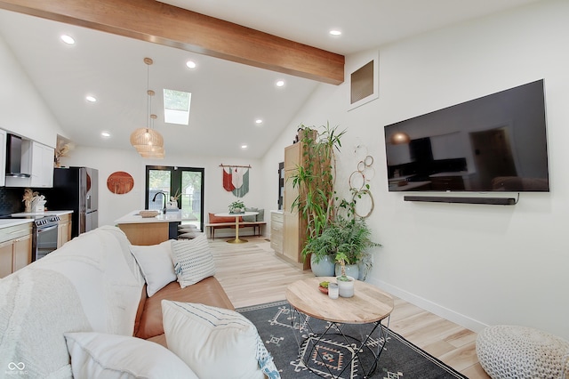 living area with a skylight, recessed lighting, light wood-type flooring, and baseboards