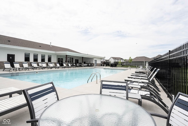 2628 Lamar Dr, Whitestown, IN 46075 - community pool featuring a patio area, fence, and outdoor dining area