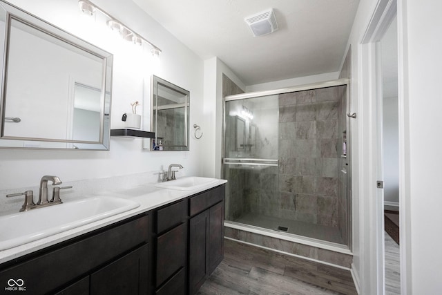 2628 Lamar Dr, Whitestown, IN 46075 - full bathroom with wood finished floors, a shower stall, and double vanity