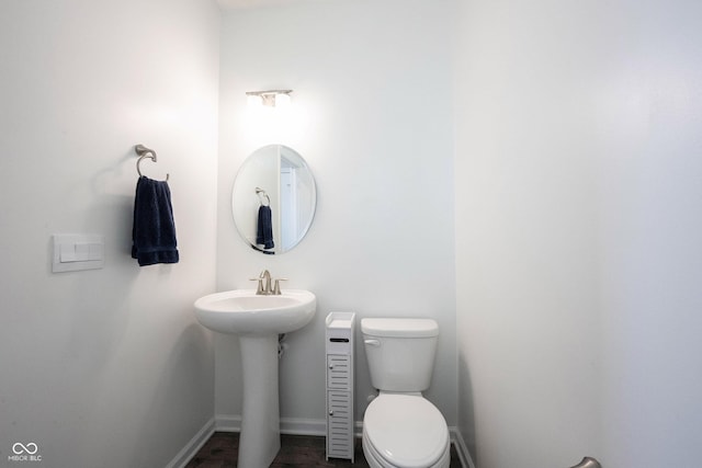 2628 Lamar Dr, Whitestown, IN 46075 - half bathroom with toilet, a sink, and baseboards