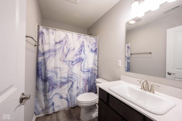 2628 Lamar Dr, Whitestown, IN 46075 - bathroom with wood finished floors, toilet, vanity, and a shower with curtain