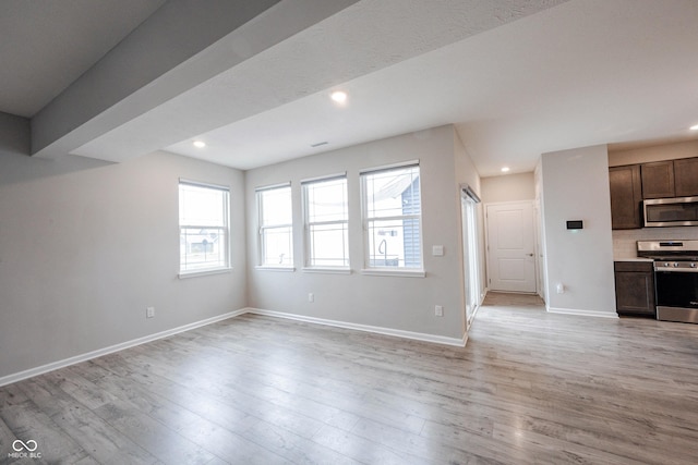 2628 Lamar Dr, Whitestown, IN 46075 - unfurnished living room featuring healthy amount of natural light, light wood-type flooring, and recessed lighting